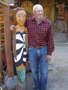 Wood carver Russ Zeitz with his "Birdfishwoman" sculpture