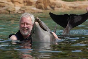 Robert Scheer with Scarlet the dolphin