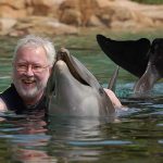 Robert Scheer with Scarlet the dolphin